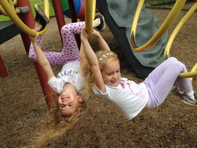 dwie dziewczynki bawią się na placu zabaw